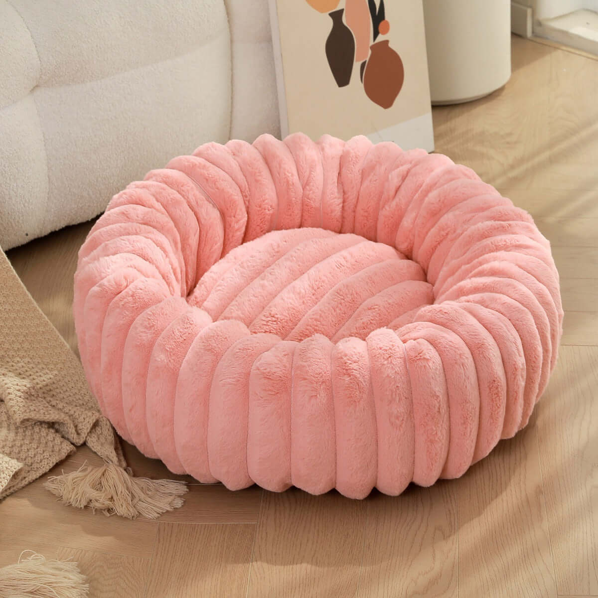 plush pet bed for winter in soft pink color, featuring cozy circular design and plush fabric.