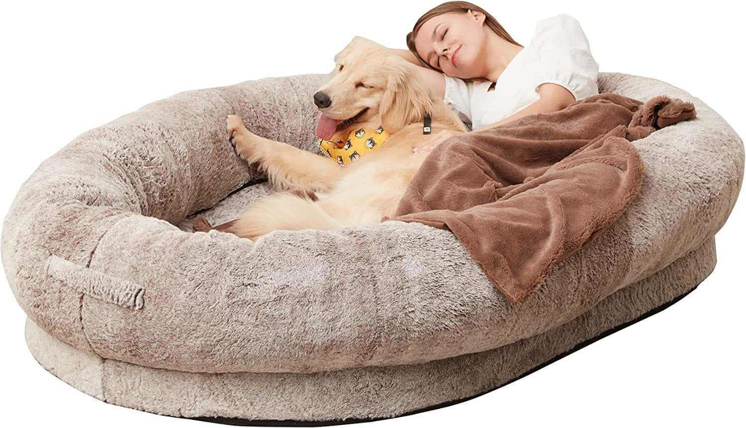 Portable pet bed for humans with a woman resting next to a golden retriever in a cozy setting.
