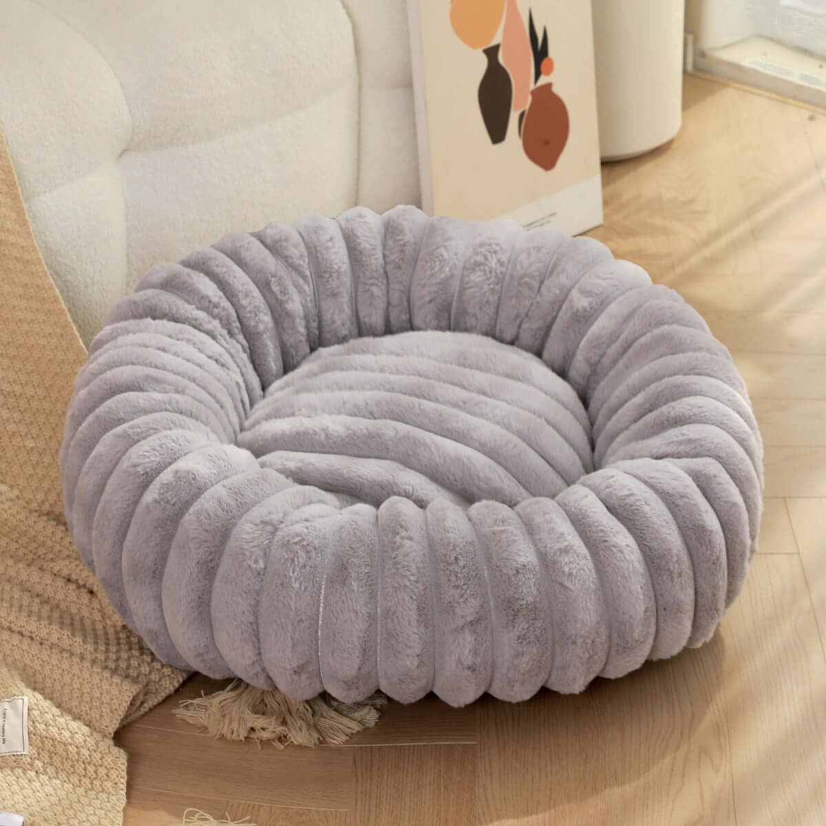 plush pet bed for winter in soft gray color with a round, cozy design